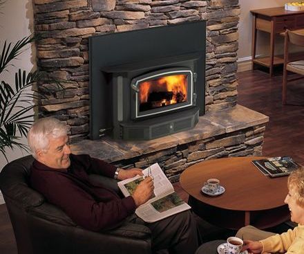 Elderly Couple sits by Regency I3100 Wood Fireplace Insert and hearth warmer 
