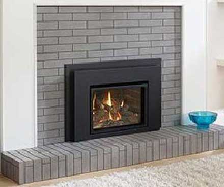 Regency L234 Traditional Gas Fireplace Insert in black with gray brick surround