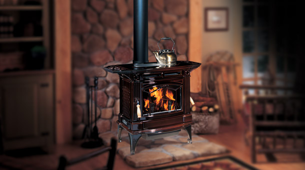 Regency H300 Hampton Cast Iron Free Standing Wood Stove Fireplace in brown with tea kettle on top