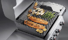 salmon, asparagus, and other vegetables on a weber grill
